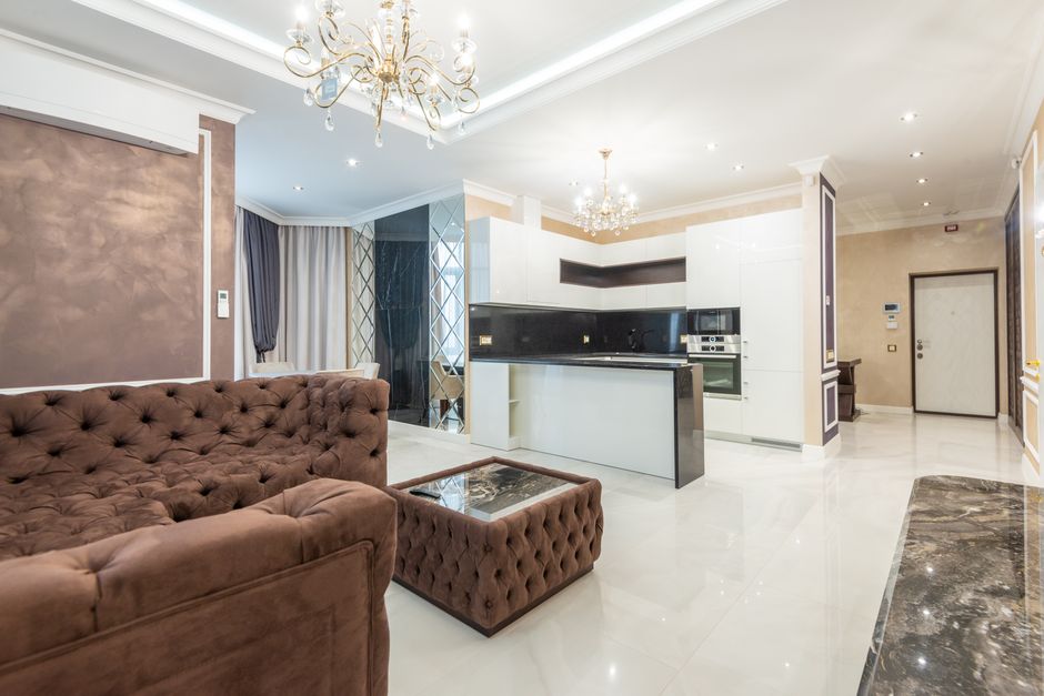 Luxurious open-plan living room with modern interior design and stylish lighting features.
