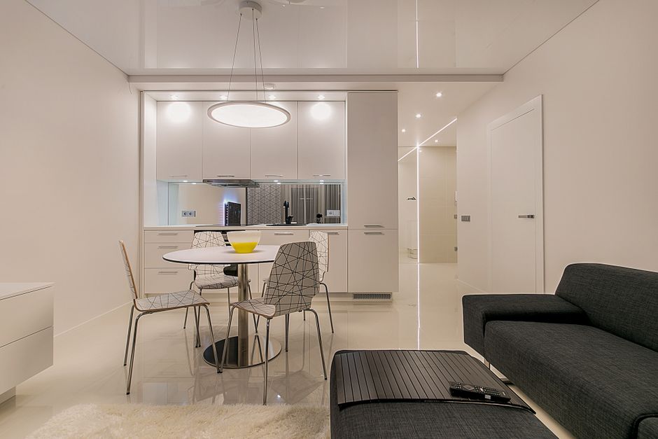 Stylish contemporary open-plan living room and kitchen with minimalist design in Vilnius.